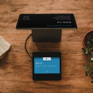 Cliente realizando un pago electrónico con tarjeta en un comercio